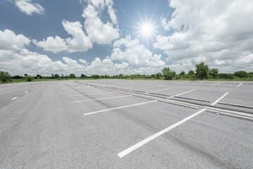Empty parking lot against mountains and beautiful blue sky. - 784694389
