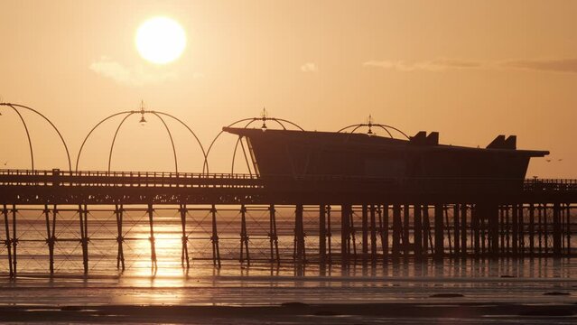 Southport pier at sunset with sun in background
