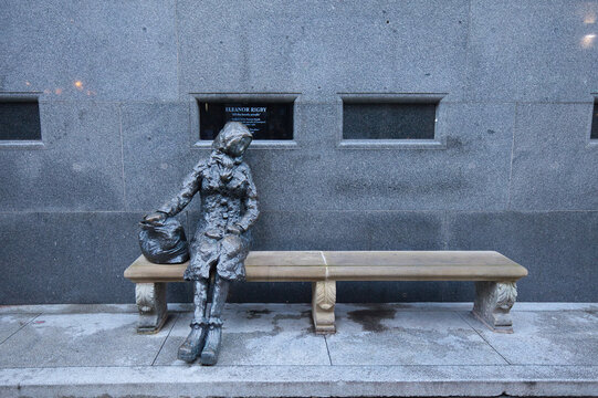 England, Liverpool - December 28, 2023: Once sung about by the Beatles, Eleanor Rigby still sits alone on a bench in Liverpool today.