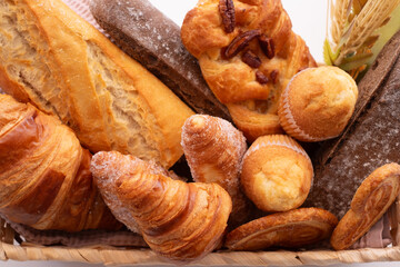 Close-up on bakery - various kinds of breadstuff. Rye bread, wholemeal, baguette, sweet bakery...
