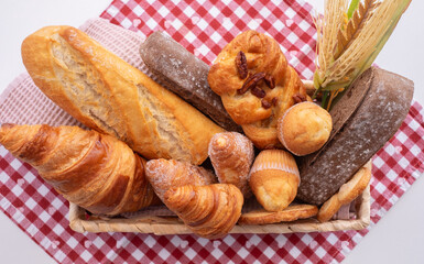 Bakery - various kinds of breadstuff. Rye bread, wholemeal, baguette, bakery products and croissant captured from above (top view, flat lay)