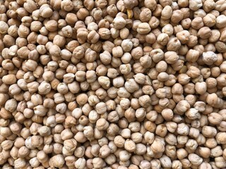 Dry organic chickpeas as background close up. Heap of white chickpeas. Food background. Biological food.
