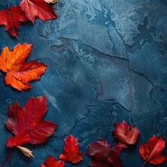 autumn background with colored red leaves on a blue slate background