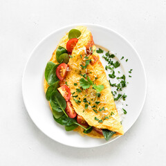 Stuffed omelette with tomatoes and spinach