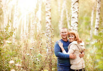 Happy smiling couple in the autumn forest