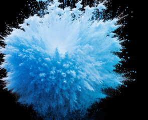 an explosion of blue powder paint . Closeup of blue dust particles splattered isolated on black background.