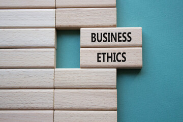 Business ethics symbol. Concept word Business ethics on wooden blocks. Beautiful grey green...