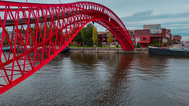 Aerial drone view of modern footbridge Python Bridge at Eastern Docklands neighborhood of Amsterdam Netherlands