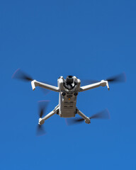 New drone with omnidirectional obstacle sensor, 4K camera and accessories parked vertically.