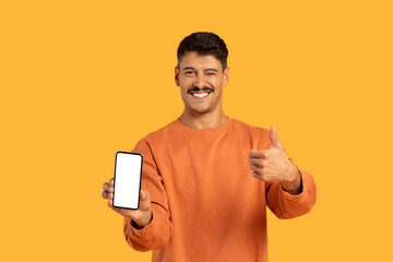 Smiling guy thumbs up showing smartphone screen