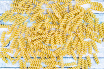 A pile of raw italian fusilli spiral pasta. Texture background.