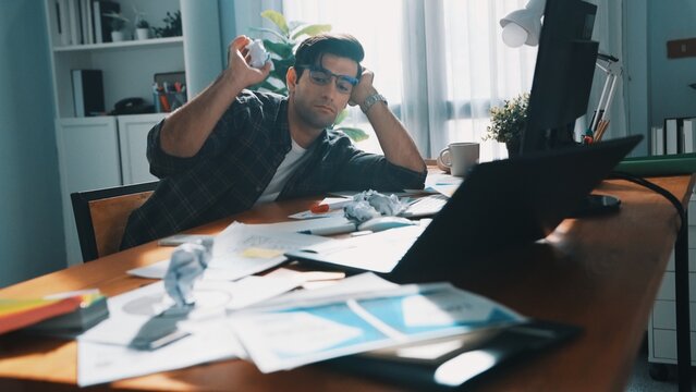 Skilled interior designer work on palettes and crumpled paper. Top view of skilled business man run out of idea while sleeping at meeting table. Project manager crumpled and throw paper. Symposium. - Powered by Adobe