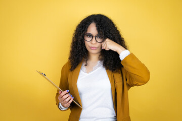 African american business woman with paperwork in hands over yellow background depressed and worry for distress, crying angry and afraid. Sad expression.