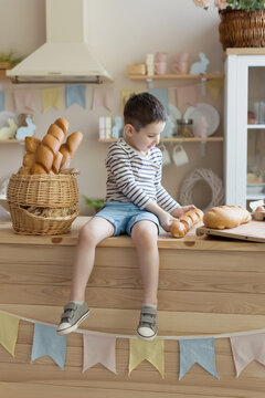 Child with baguettes on kitchen