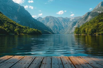 A tranquil scene with clear waters nestled among towering mountains viewed from a rustic wooden dock