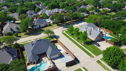 Two story suburban single-family home with swimming pool, large backyard, tall wooden fence in...