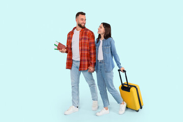 Couple ready for a trip with passport and suitcase