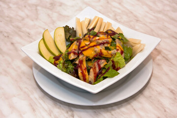 Pear and vegetable salad with mango and strawberry dressing, fresh green salad