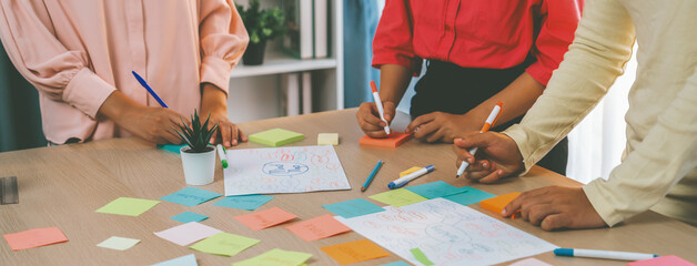 Group of young business group brainstorms ideas on colorful sticky notes. A portrait of startup...