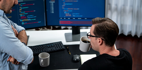 IT developers discussing online software development information on pc screen, creating program...