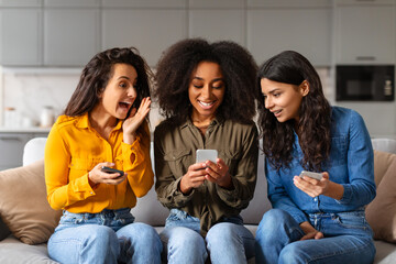 Friends reacting to smartphone content, have home party - 784768706