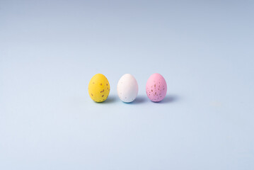 Chocolate colored Easter eggs speckled on a blue background. Minimalism Easter concept