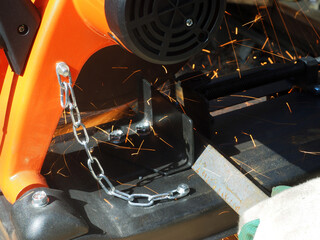 Sparks from cutting metal with angle grinder. Sparks while grinding iron.
The concept of locksmith work, processing of metal products.

