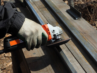 A worker processes metal with an angle grinder on a construction site.
The concept of locksmith...