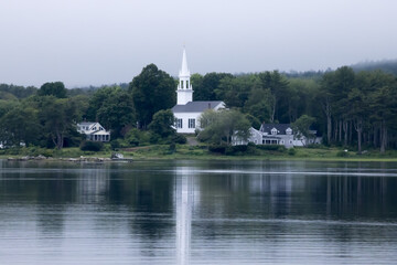 Fototapeta na wymiar White church reflected in a river