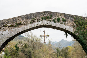 Roman bridge in the town of Cangas de Onis, Asturias, Spain - 784770394