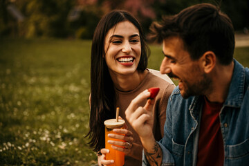 Couple making memories over a picnic feast outdoors