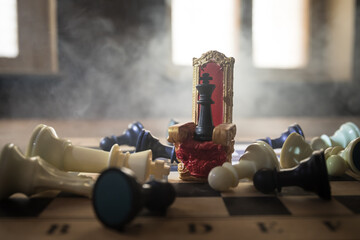 Red royal chair miniature on wooden table. Medieval Throne on chessboard. Chess board game concept of business ideas and competition and strategy ideas concept. Selective focus