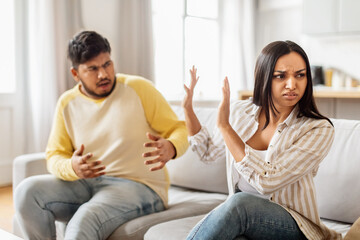 Couple arguing on the couch at home