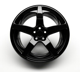 Obraz premium Black wheel on white background with reflection of the spokes.