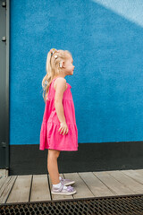 Naklejka premium Funny baby with cochlear implant spend time outdoor. Hearing aid and medicine innovating technology and diversity inclusion concept.