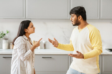 Indian couple arguing in a kitchen interior