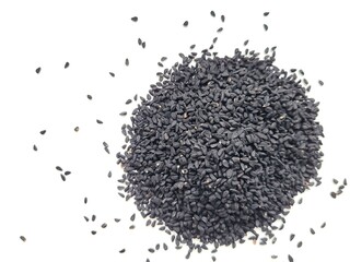 Black cumin seeds on white background.