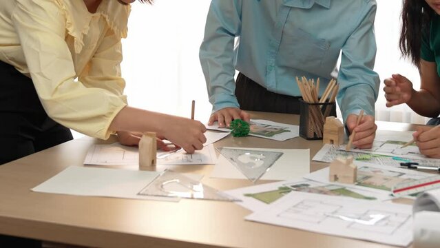 A video of architect use measurement tools and pencil to measure blueprint. Architect design house construction on a table at studio, with architectural plan scattered around. Focus hand. Delineation.