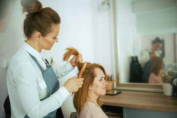 40 years old hair salon employee in modern hair studio