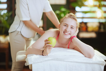 massage therapist woman in massage cabinet making massage - 784788948