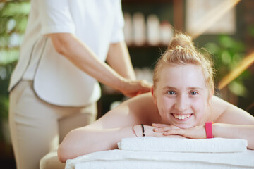 female therapist in massage cabinet making massage