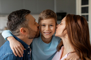 Happy family moment with parents kissing child