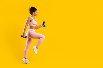 Fototapeta na wymiar Focused black lady doing fitness exercise isolated