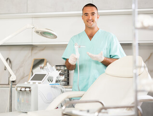 Portrait of friendly doctor in beauty clinic, in the ward of hardware procedures for facial skin rejuvenation