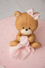 Pink cake decorated with a teddy bear