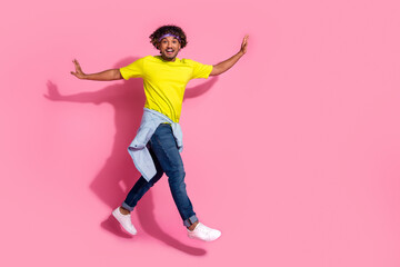 Fototapeta na wymiar Photo of cheerful glad man wear stylish yellow clothes walk empty space isolated on pink color background