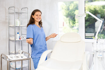 Female cosmetic doctor stands confidently in her well-equipped office, ready to provide expert skincare solutions to her patients.