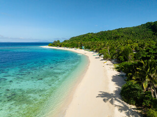 Beautiful white sand beach and crystal clear water. Cobrador Island. Romblon, Philippines.