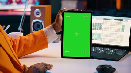 African american girl holding tablet with greenscreen layout, conducting data analysis for...