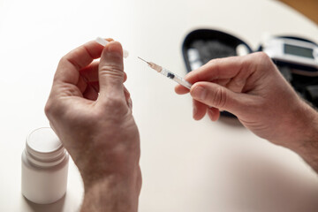 Unknown diabetic man with syringe preparing for insulin injection